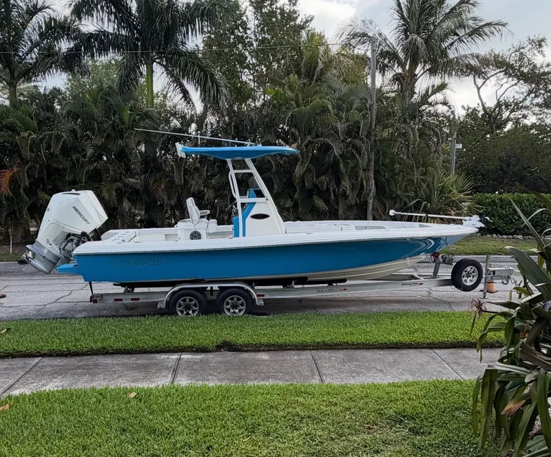 Slide: The Image of 2020 ShearWater Carolina boat on trailer, surrounded by palm trees. - 33
