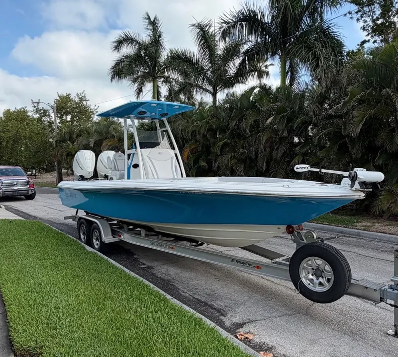 Slide: The Image of 2020 ShearWater Carolina boat on trailer, palm trees in background. - 34