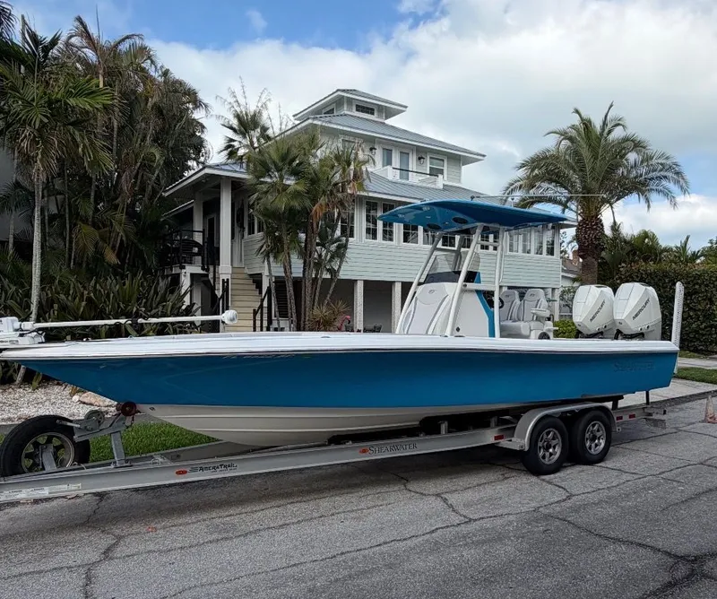 Slide: The Image of 2020 ShearWater Carolina boat on trailer in front of tropical house. - 35