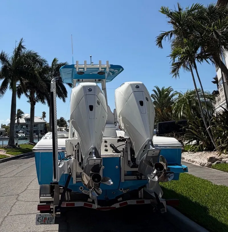 Slide: The Image of 2020 ShearWater Carolina boat with dual outboard motors, palm trees in background. - 37