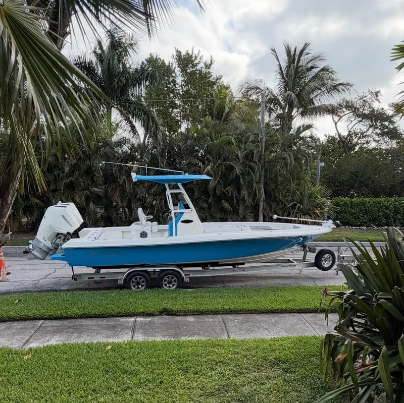 Slide: The Image of 2020 ShearWater Carolina boat on trailer, surrounded by palm trees. - 38