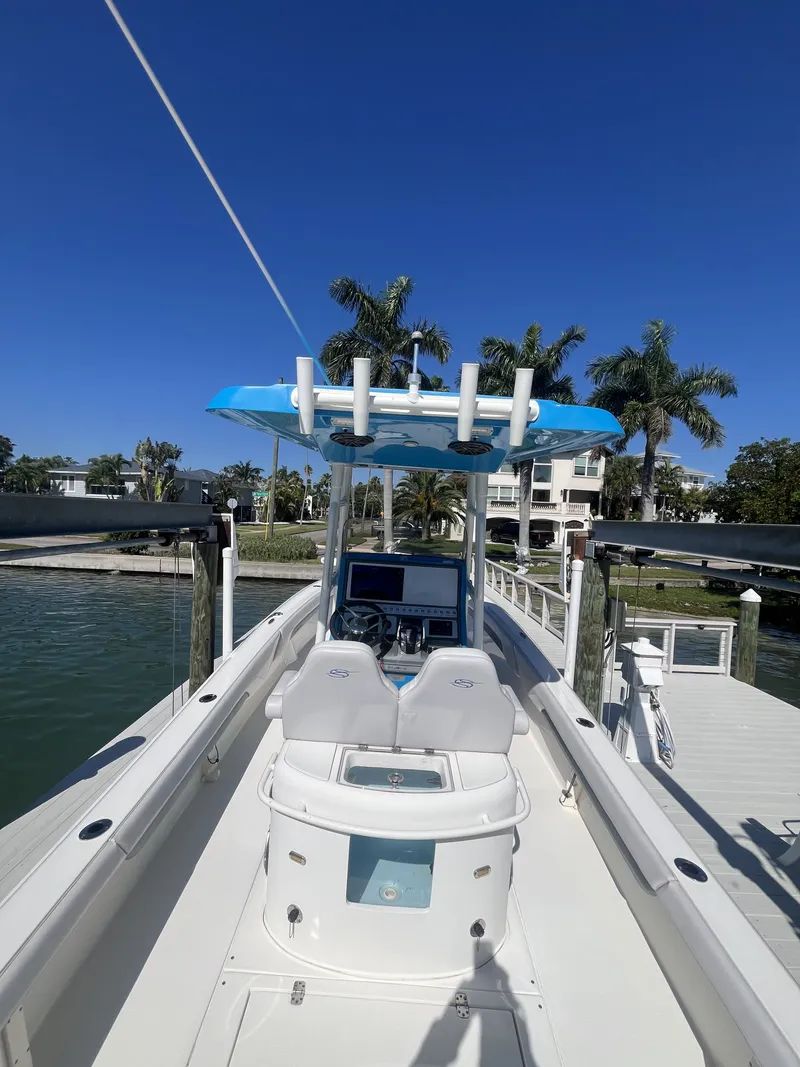Slide: The Image of ShearWater Carolina 2020 boat docked with palm trees in background. - 6