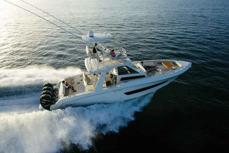 Slide: The Image of Manufacturer Provided Image: 2025 Boston Whaler 420 Outrage cruising on open water, showcasing sleek design and powerful engines. - 2
