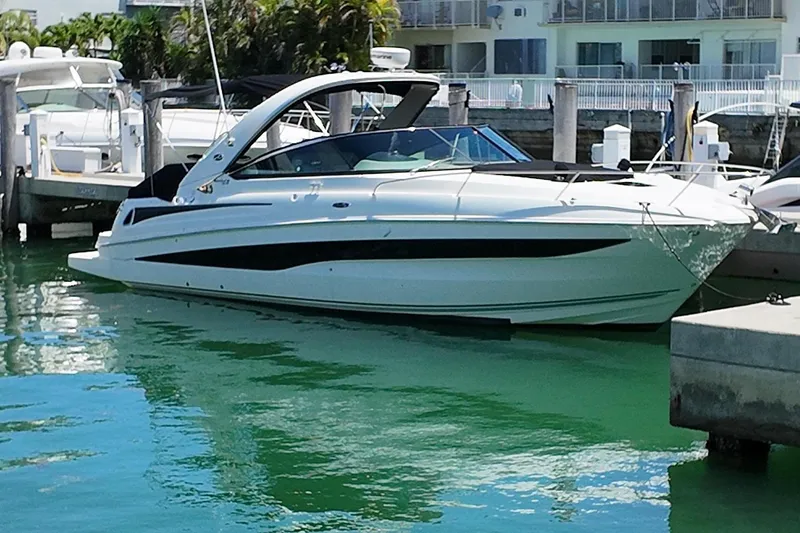 The Image of 2015 Sea Ray 370 Venture yacht docked in harbor. - 1