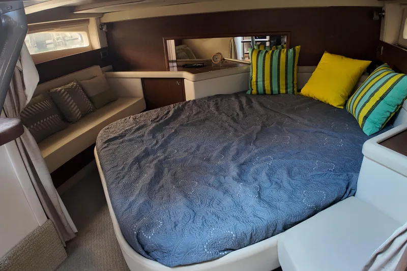 Slide: The Image of Luxurious cabin interior of 2015 Sea Ray 370 Venture with cozy bedding and vibrant pillows. - 9