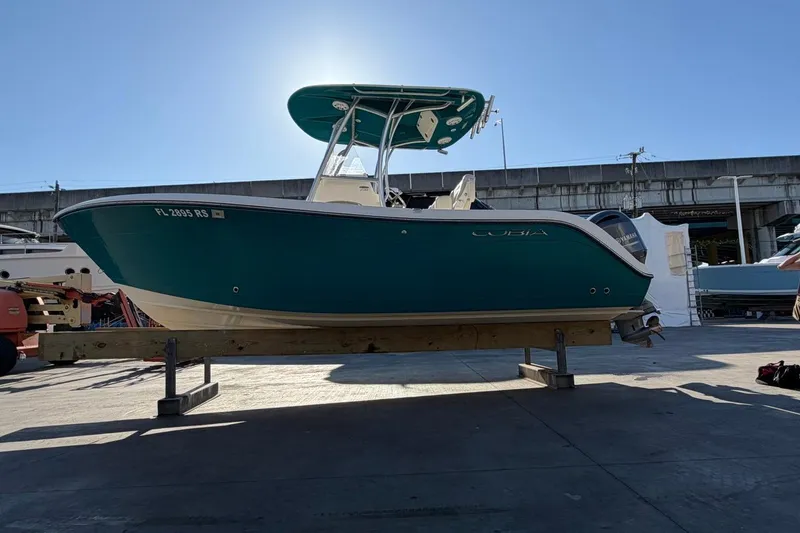 The Image of 2018 Cobia 220 Center Console boat on display in a marina setting. - 0