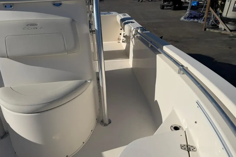 Slide: The Image of 2018 Cobia 220 Center Console boat interior with seating and railings. - 13