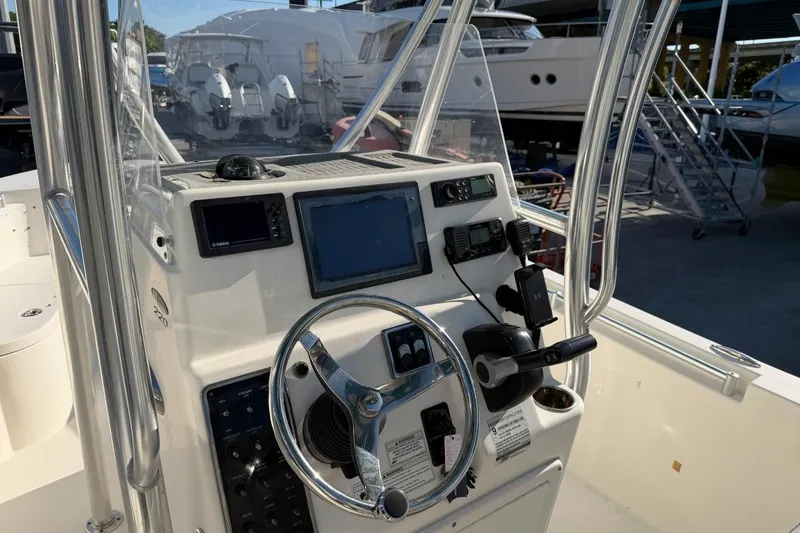 Slide: The Image of 2018 Cobia 220 Center Console boat dashboard with steering wheel and navigation equipment. - 9