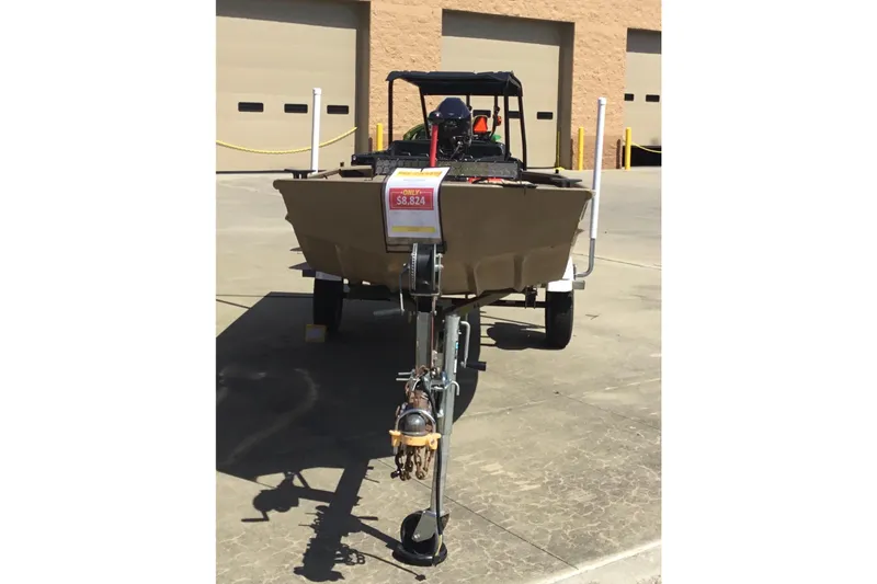 Slide: The Image of 2024 SeaArk 1448 MV boat on trailer, displayed outdoors with price tag. - 4