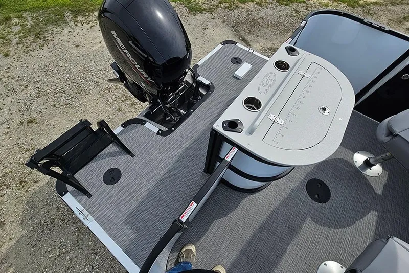 Slide: The Image of 2026 Bentley Pontoons 243 FNC deck with Mercury outboard motor and fishing setup. - 11