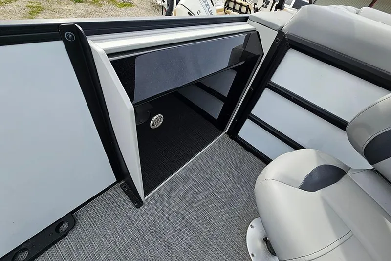 Slide: The Image of 2026 Bentley Pontoons 243 FNC interior with seating and storage compartment. - 14