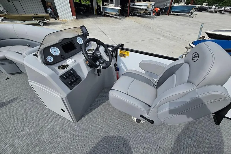 Slide: The Image of 2026 Bentley Pontoons 243 FNC boat interior with steering console and plush seating. - 18