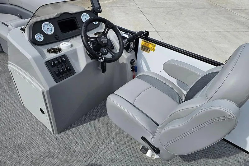 Slide: The Image of 2026 Bentley Pontoons 243 FNC boat interior with steering console and plush seating. - 19
