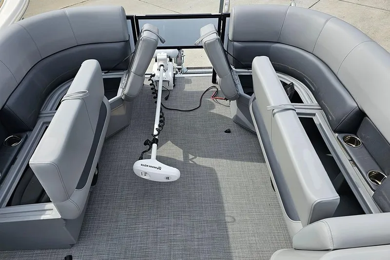 Slide: The Image of 2026 Bentley Pontoons 243 FNC interior with gray seating and fishing equipment. - 23