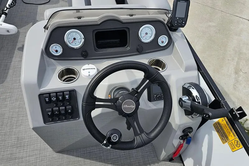 Slide: The Image of Steering console of 2026 Bentley Pontoons 243 FNC, featuring gauges and controls. - 24