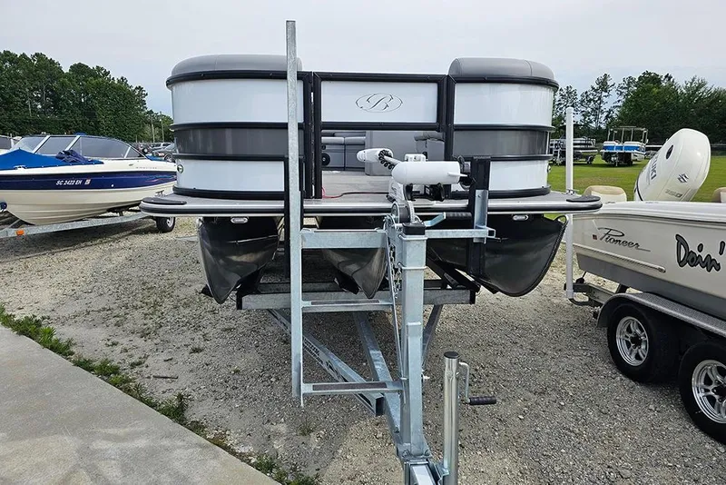 Slide: The Image of 2026 Bentley Pontoons 243 FNC Fish N Cruise on trailer, parked outdoors. - 4