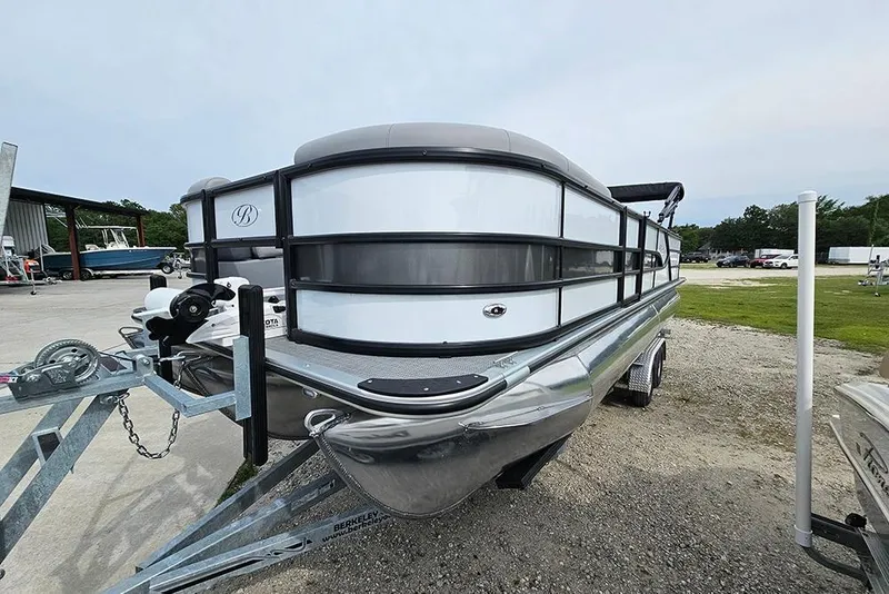 Slide: The Image of 2026 Bentley Pontoons 243 FNC Fish N Cruise on trailer, parked outdoors. - 5