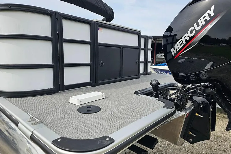 Slide: The Image of 2026 Bentley Pontoons 243 FNC with Mercury outboard motor, showcasing rear deck and railing. - 9