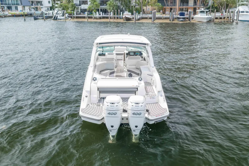 Slide: The Image of 2023 Sea Ray SLX 350 Outboard boat with dual engines on water. - 13