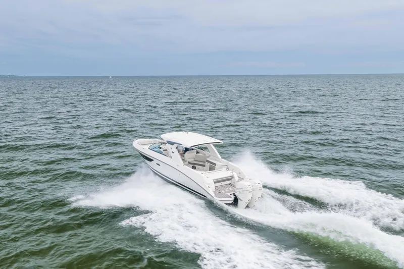Slide: The Image of 2023 Sea Ray SLX 350 Outboard cruising on open water. - 20