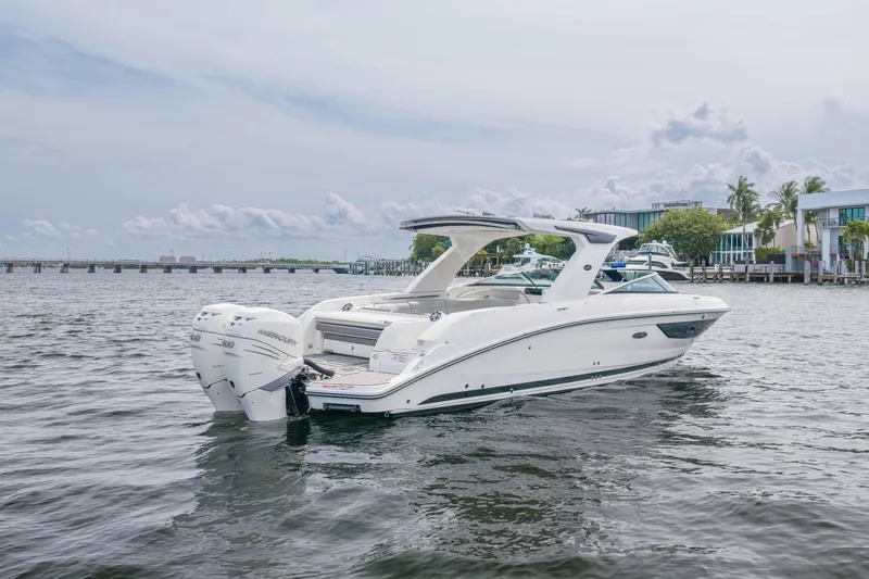 Slide: The Image of 2023 Sea Ray SLX 350 Outboard boat on water, showcasing sleek design and powerful engines. - 6