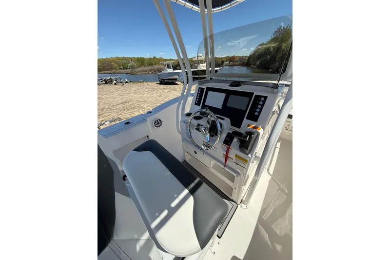 Slide: The Image of 2023 Robalo R202 Explorer boat cockpit with steering wheel and control panel. - 10