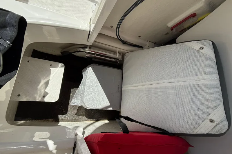 Slide: The Image of 2023 Robalo R202 Explorer boat interior with seating and storage area. - 12