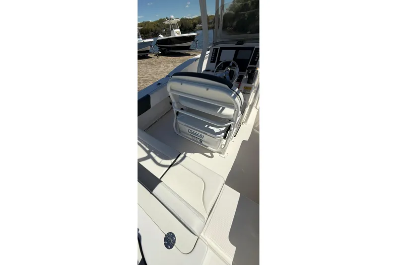 Slide: The Image of 2023 Robalo R202 Explorer boat interior with helm and seating area. - 13