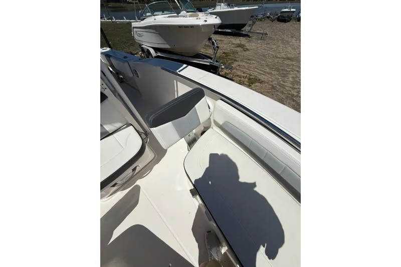 Slide: The Image of 2023 Robalo R202 Explorer boat interior with seating and shadow on deck. - 16