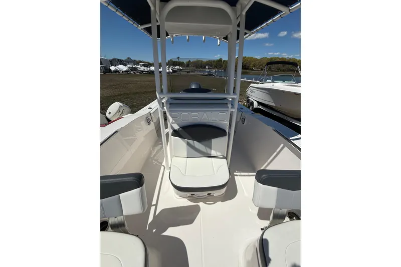 Slide: The Image of 2023 Robalo R202 Explorer boat interior with seating and console under blue sky. - 17