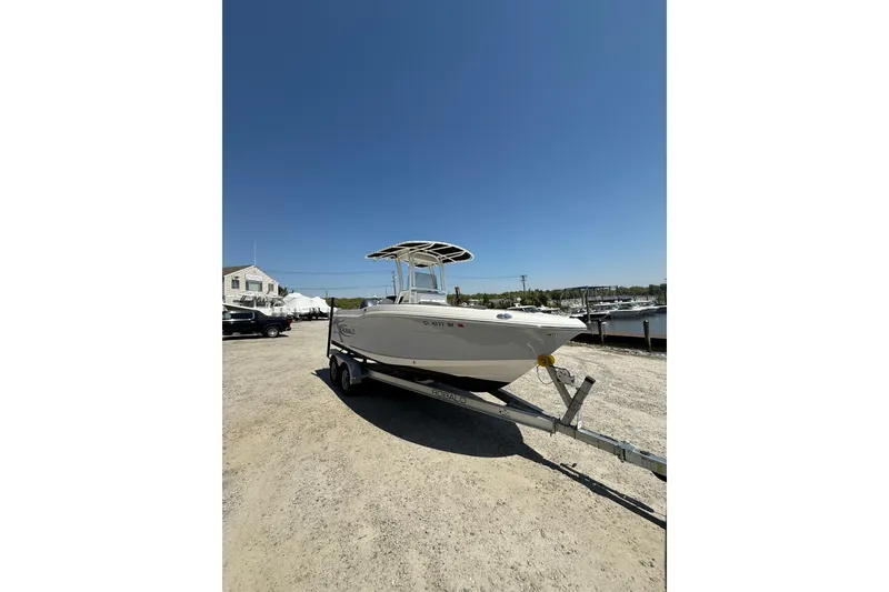 Slide: The Image of 2023 Robalo R202 Explorer boat on trailer under clear blue sky. - 2