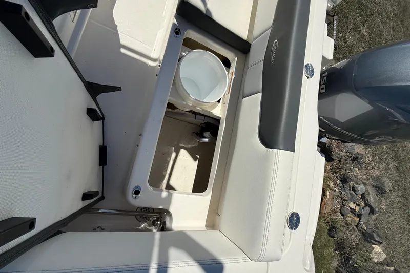 Slide: The Image of 2023 Robalo R202 Explorer boat interior with storage compartment and engine view. - 22