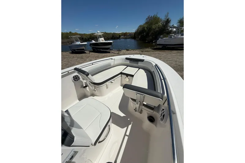 Slide: The Image of 2023 Robalo R202 Explorer boat interior with seating, docked near water. - 9