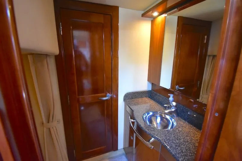Slide: The Image of Luxurious bathroom of 2007 Sea Ray 48 Sundancer with wood paneling. - 26