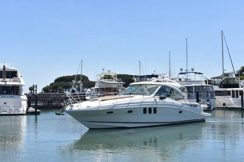 Slide: The Image of 2007 Sea Ray 48 Sundancer yacht in harbor, surrounded by other boats. - 3