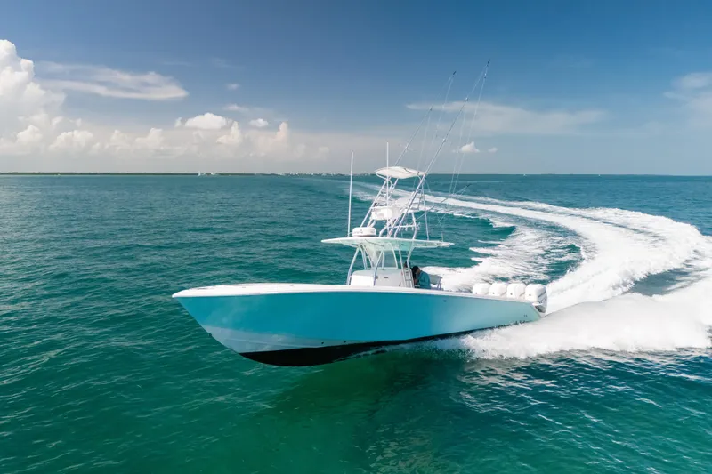 The Image of 2006 Venture 39 Open boat cruising on clear blue ocean waters. - 0