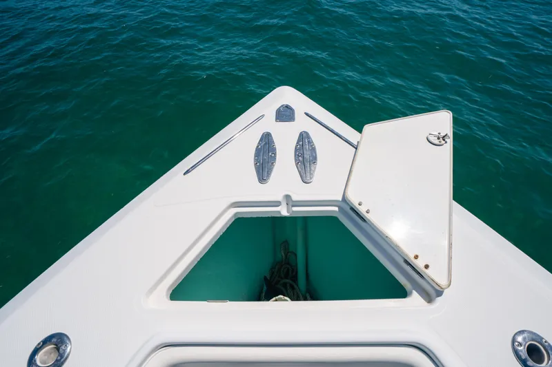 Slide: The Image of Bow of 2006 Venture 39 Open boat with open hatch, floating on clear blue water. - 12