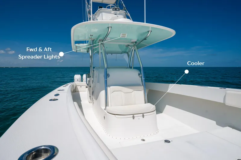 Slide: The Image of 2006 Venture 39 Open boat with spreader lights and cooler on deck, under clear blue sky. - 14