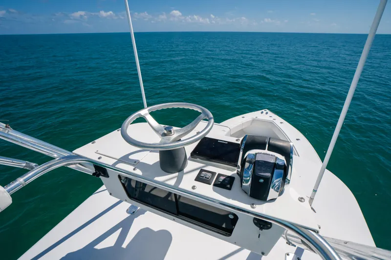 Slide: The Image of 2006 Venture 39 Open boat helm with ocean view, featuring steering wheel and controls. - 33