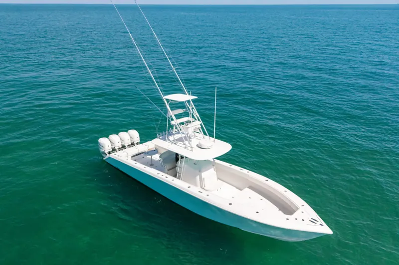Slide: The Image of 2006 Venture 39 Open boat on calm ocean waters, featuring multiple outboard engines. - 6