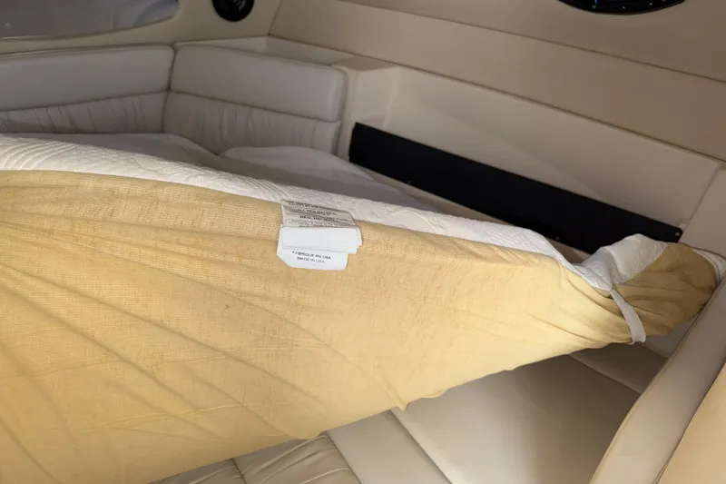 Slide: The Image of Interior cabin of a 2005 Regal Commodore 2665 boat with beige upholstery. - 10