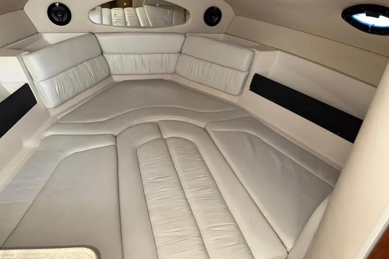 Slide: The Image of Interior cabin of a 2005 Regal Commodore 2665 boat with white leather seating. - 11