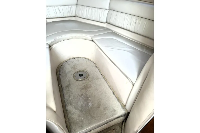 Slide: The Image of Interior seating of 2005 Regal Commodore 2665 boat, featuring white cushioned benches. - 13
