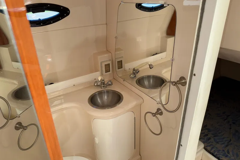 Slide: The Image of Compact bathroom in 2005 Regal Commodore 2665 boat with sink and mirror. - 19