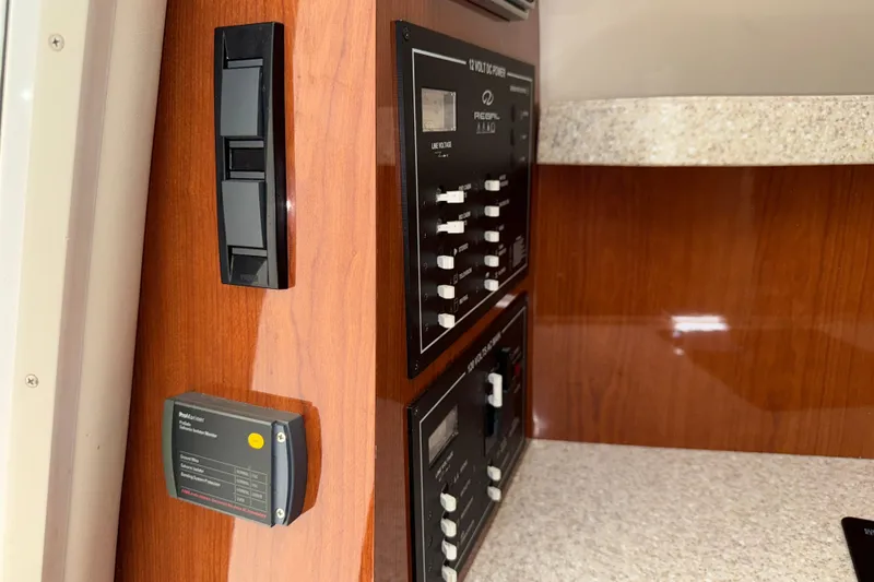 Slide: The Image of Control panel of a 2005 Regal Commodore 2665 boat with wood finish. - 24