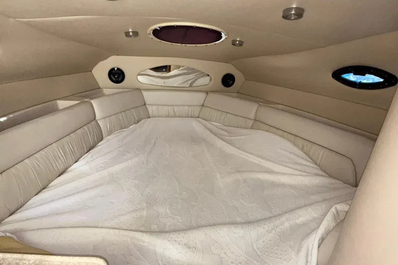 Slide: The Image of Interior cabin of 2005 Regal Commodore 2665 boat with beige upholstery and bedding. - 28