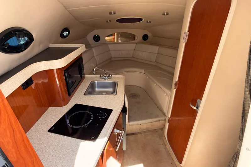 Slide: The Image of 2005 Regal Commodore 2665 cabin interior with kitchenette and seating area. - 29