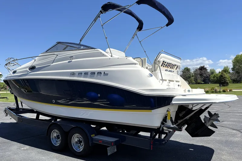 Slide: The Image of 2005 Regal Commodore 2665 boat on trailer, featuring sleek design and dual propellers. - 3