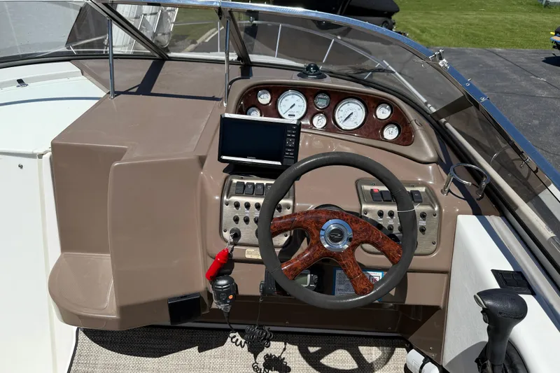 Slide: The Image of Cockpit of 2005 Regal Commodore 2665 boat with steering wheel and instrument panel. - 32