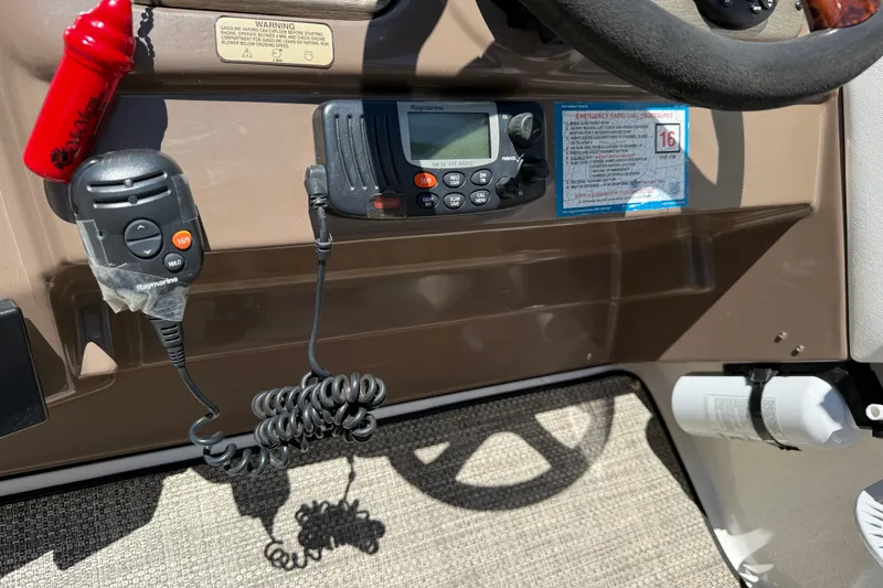 Slide: The Image of Control panel of a 2005 Regal Commodore 2665 boat with radio and fire extinguisher. - 33